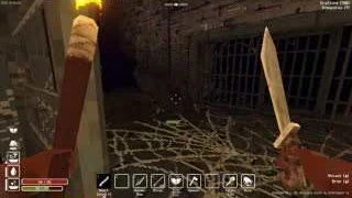 A Torch beside webs across a narrow stone passage in front of a barred doorway